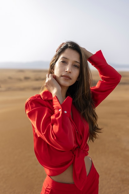 Medium shot woman posing in desert