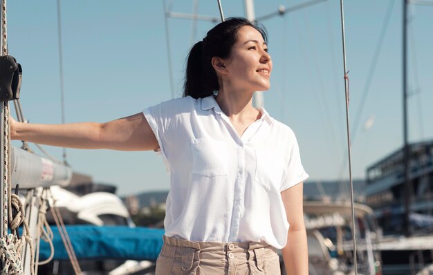 Medium shot woman posing in harbor