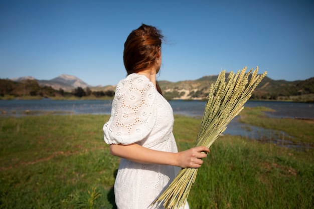 Medium shot woman posing in nature