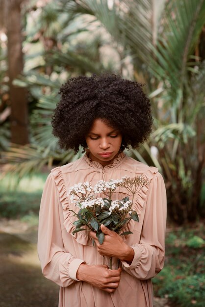 medium shot woman posing in romantic garden