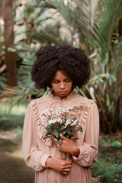 Medium shot woman posing in romantic garden