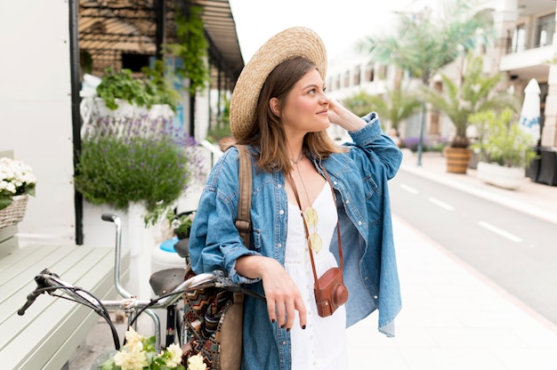 Medium shot woman posing with bike