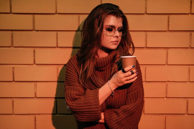 Medium shot woman posing with coffee cup
