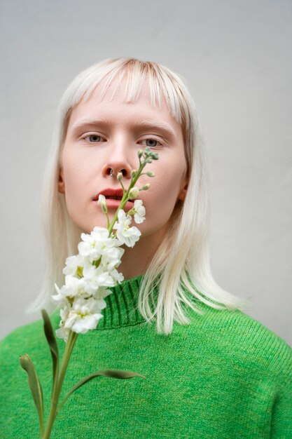 Medium shot woman posing with flower