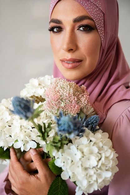 Medium shot woman posing with flowers