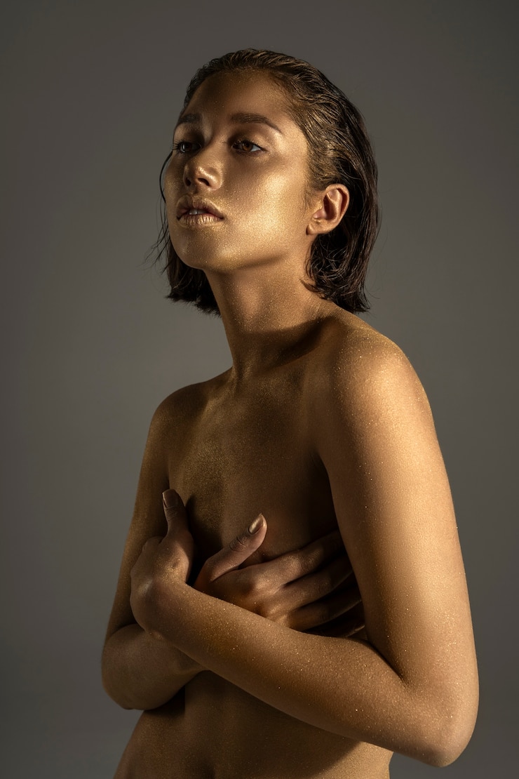 Free Photo medium shot woman posing with gold body painting