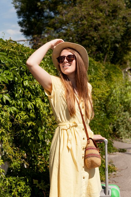 Medium shot woman posing with hat