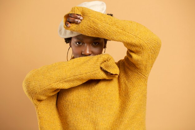 Medium shot woman posing with hat