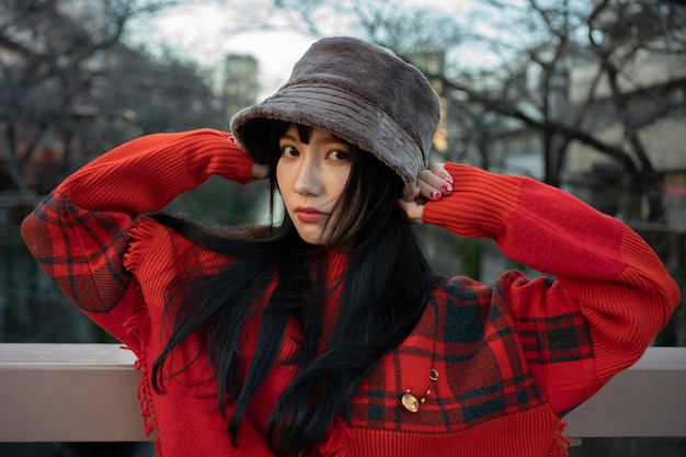 Medium shot woman posing with hat