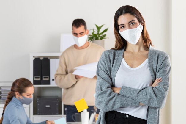 Medium shot woman posing with mask