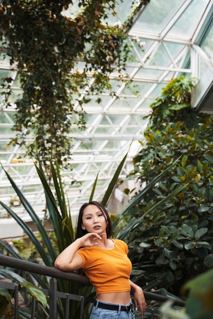 Free photo medium shot woman posing with plants