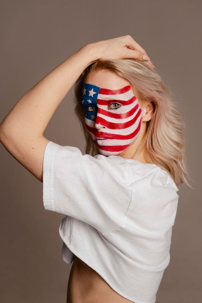 Free photo medium shot woman posing with usa makeup