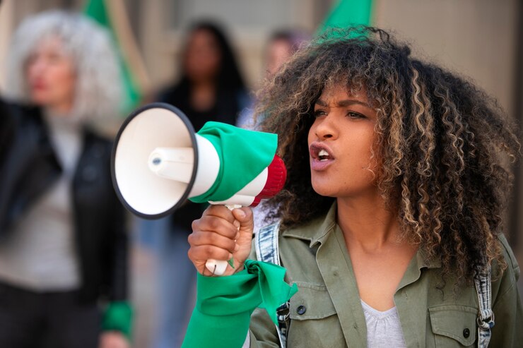 Medium shot woman protesting outdoors