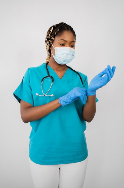 Medium shot woman putting on gloves