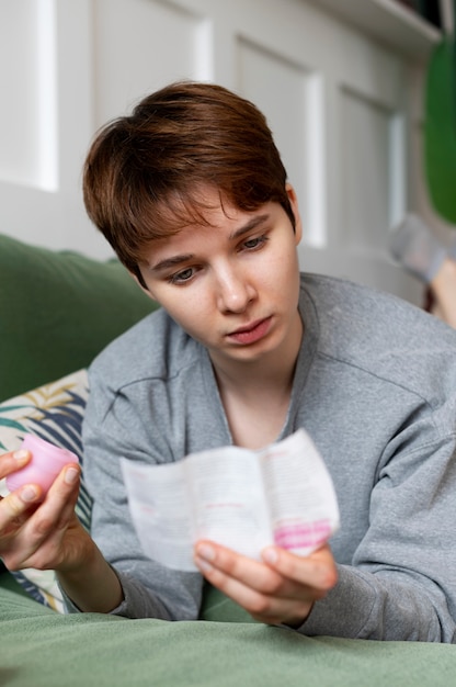 Free photo medium shot woman reading about menstrual cup