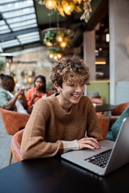 Medium shot woman reading in coffee shop