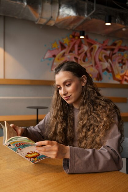 Medium shot woman reading comics