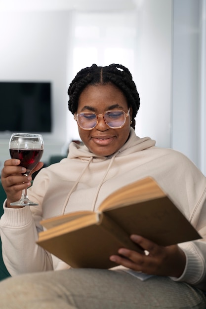 Medium shot woman reading at home