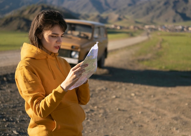 Medium shot woman reading map