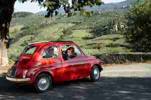 Free photo medium shot woman in red car