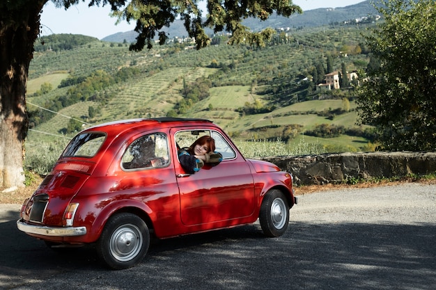 Medium shot woman in red car