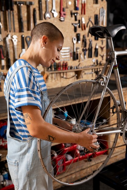 Medium shot woman repairing bicycle