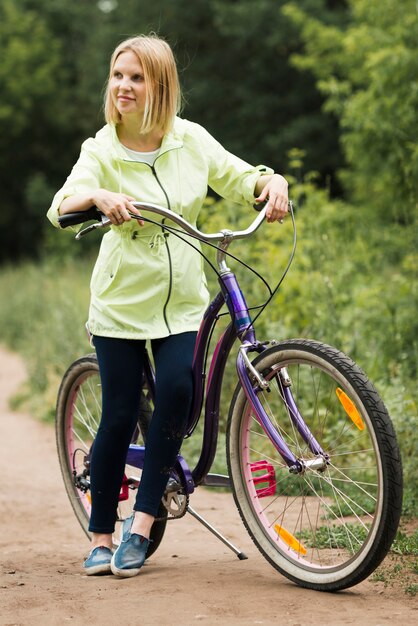 ミディアムショットの女性が自転車で休む