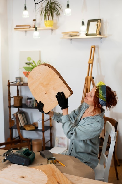 medium shot woman restoring furniture