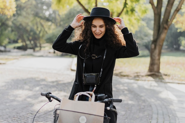 Free photo medium shot woman riding the bicycle