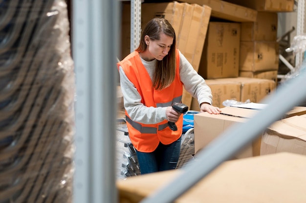 Medium shot woman scanning box