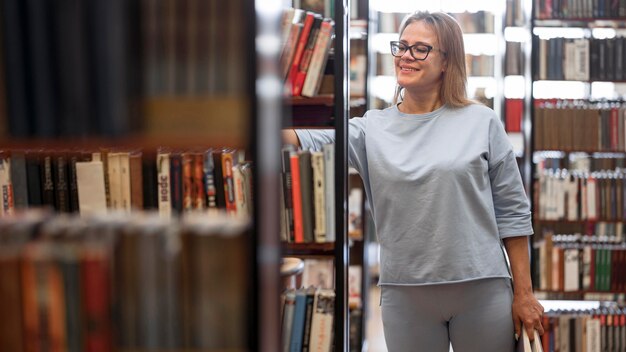 Medium shot woman searching books