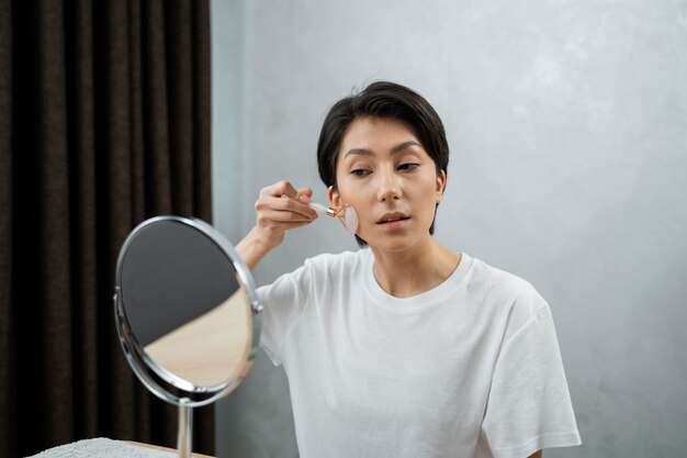 Medium shot woman selfcare with mirror