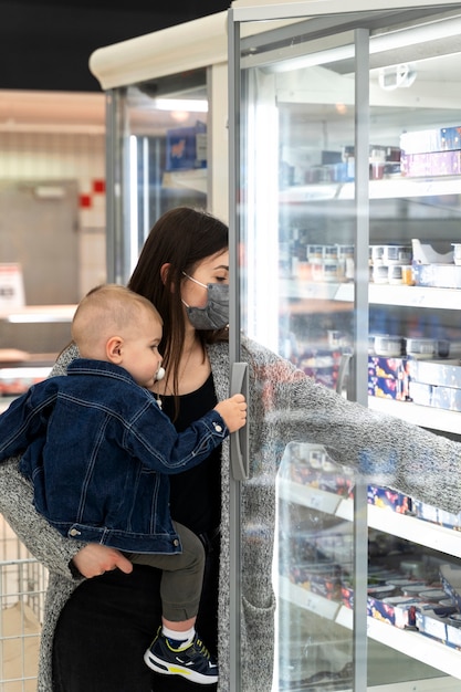 Medium shot woman shopping with kid