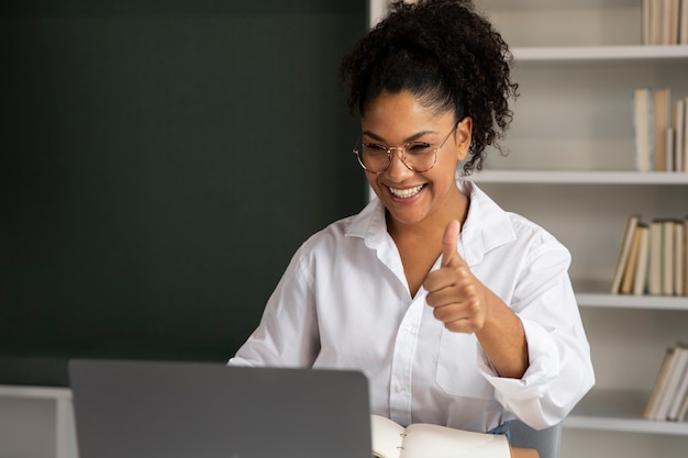 Medium shot woman showing thumbs up