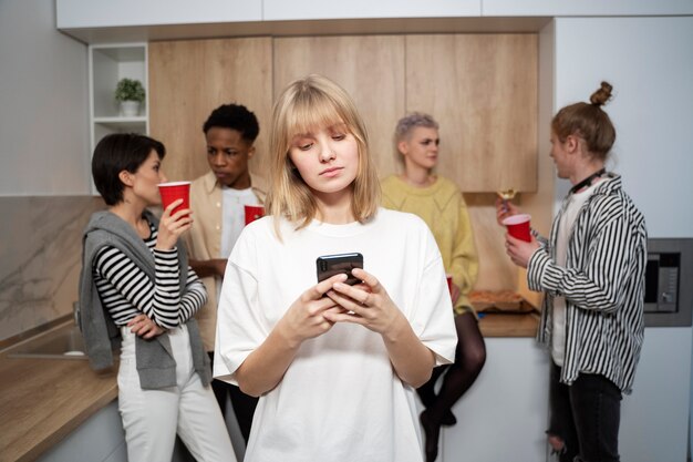 Medium shot woman sitting alone at party