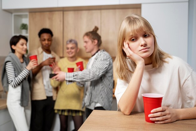 Medium shot woman sitting alone with cup