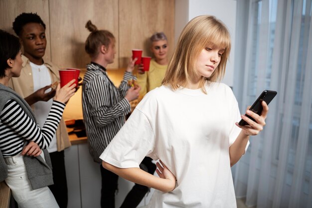 Medium shot woman sitting alone with phone