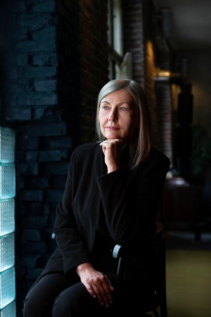 Medium shot woman sitting on chair