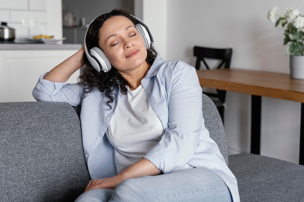 Medium shot woman sitting on couch