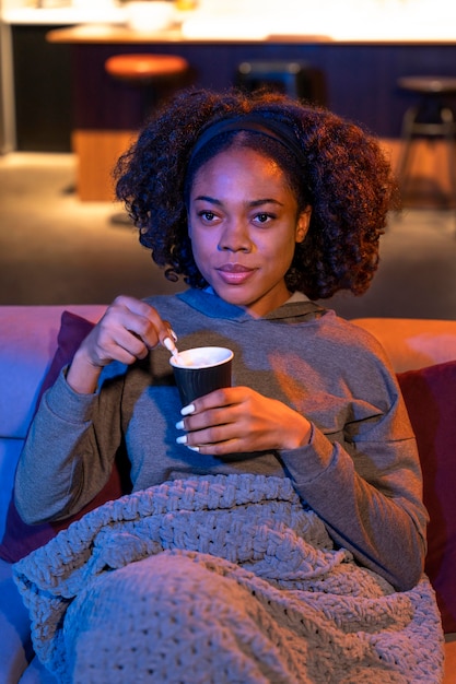 Medium shot woman sitting on couch