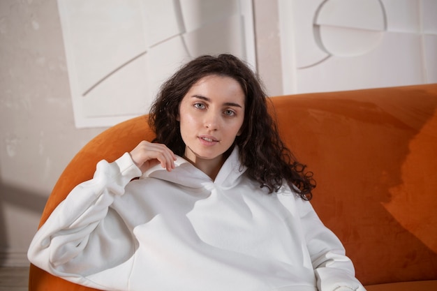 Medium shot woman sitting on couch