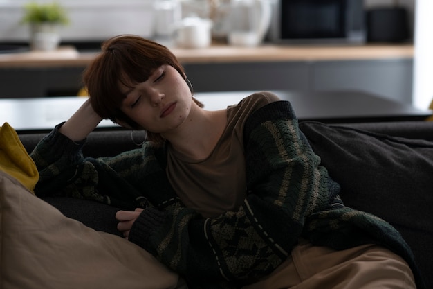 Medium shot woman sitting on couch