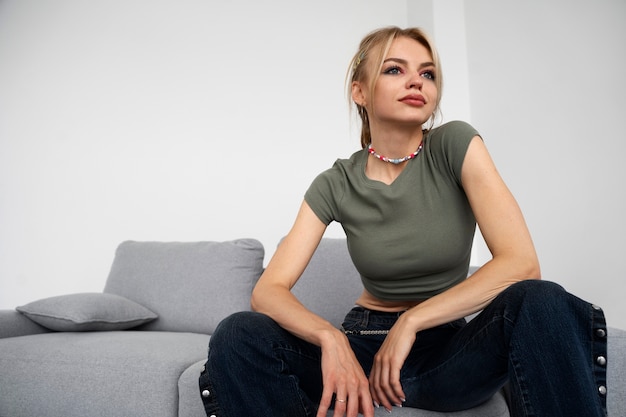 Free photo medium shot woman sitting on couch