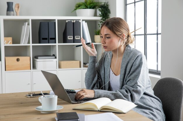 Medium shot woman sitting at desk