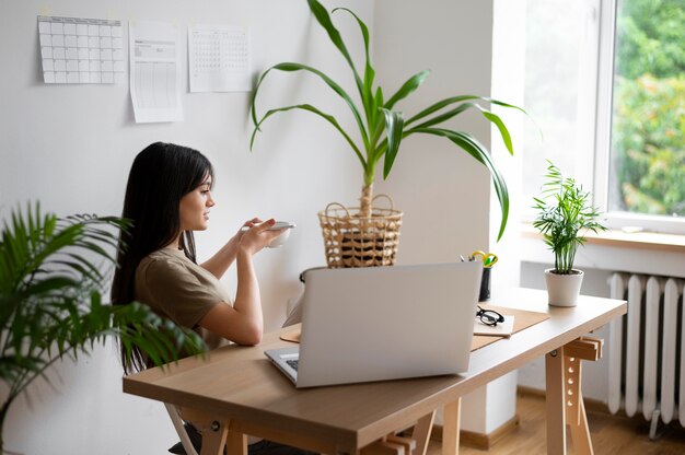 Free Photo medium shot woman sitting at desk