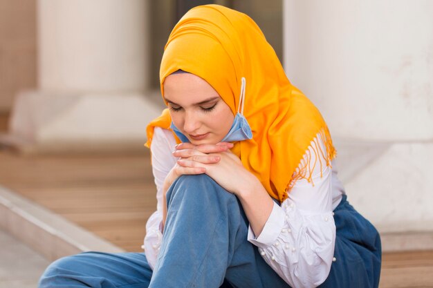 Medium shot woman sitting on floor