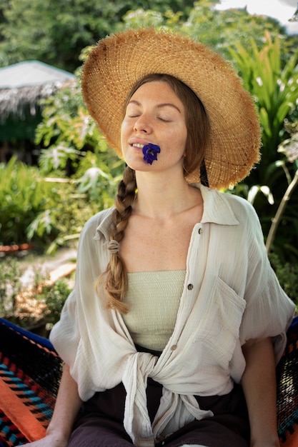 Free photo medium shot woman sitting in hammock