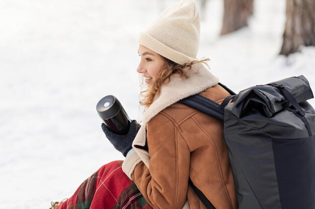 Medium shot woman sitting outdoors