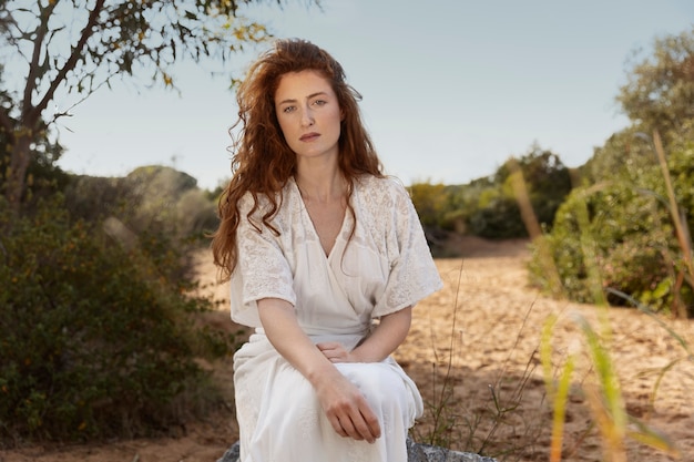 Medium shot woman sitting outdoors