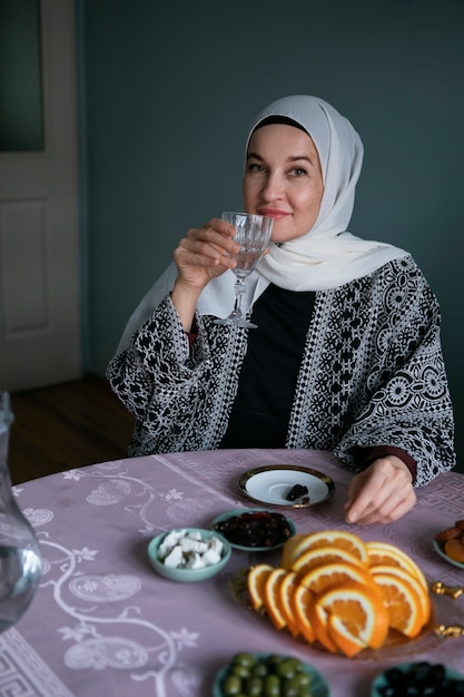 Free photo medium shot woman sitting at table